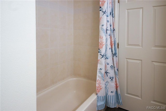 bathroom featuring shower / bathtub combination with curtain