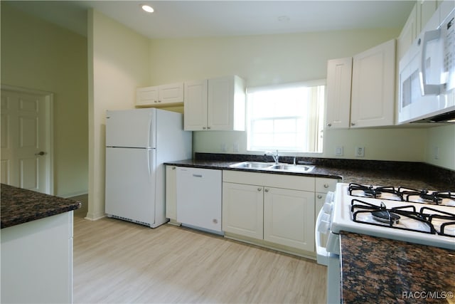 kitchen with white cabinetry, sink, and white appliances