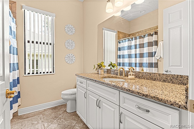 bathroom featuring tile patterned floors, vanity, and toilet