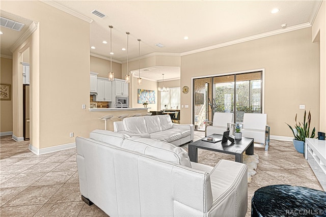 living room featuring crown molding, light tile patterned floors, and a notable chandelier