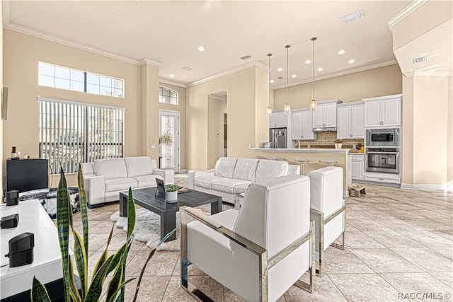 tiled living room featuring a towering ceiling and crown molding