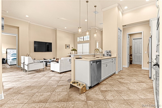 kitchen featuring pendant lighting, sink, crown molding, appliances with stainless steel finishes, and white cabinetry