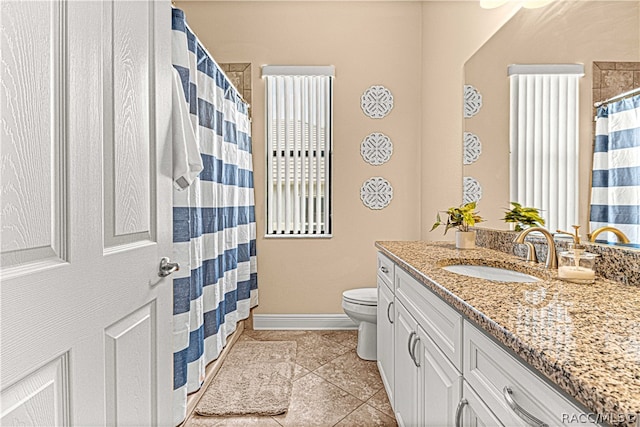 bathroom with tile patterned floors, vanity, and toilet