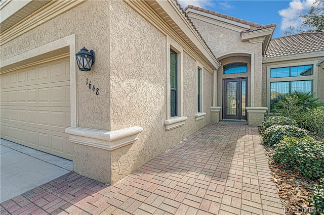 property entrance featuring french doors and a garage