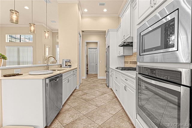 kitchen featuring sink, white cabinets, pendant lighting, and appliances with stainless steel finishes