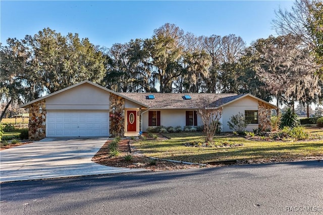 ranch-style home featuring a front lawn and a garage