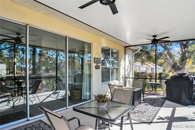 sunroom / solarium featuring ceiling fan