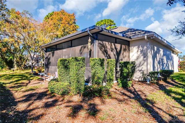 view of home's exterior with a sunroom