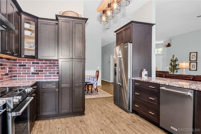 kitchen featuring light stone countertops, high quality appliances, dark brown cabinetry, and light hardwood / wood-style flooring