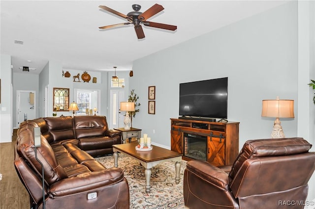 living room with ceiling fan and wood-type flooring