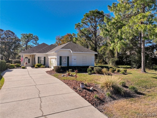 ranch-style house featuring a front yard and a garage