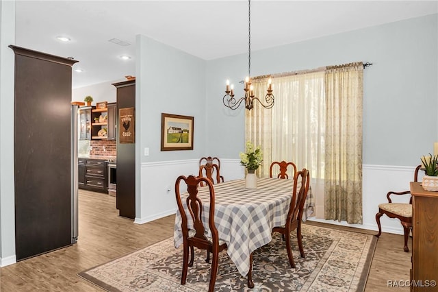 dining room featuring a chandelier and light hardwood / wood-style flooring