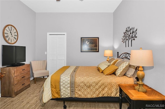 bedroom with a closet and light hardwood / wood-style floors