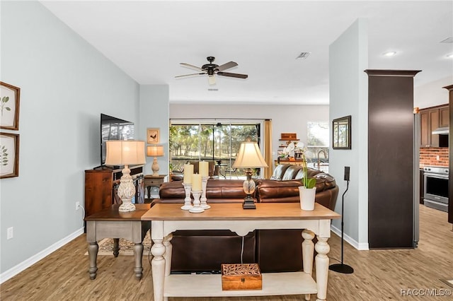 living room with ceiling fan and light hardwood / wood-style floors