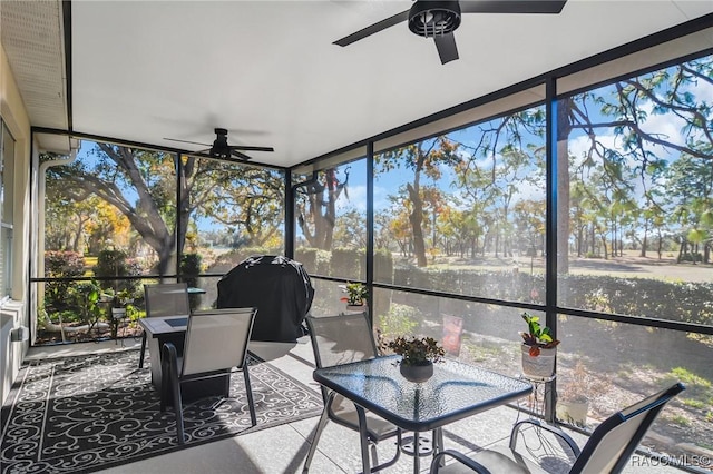 unfurnished sunroom featuring ceiling fan