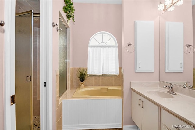 bathroom featuring shower with separate bathtub and vanity