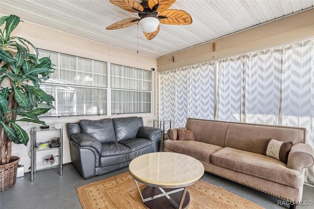 living room with concrete floors and ceiling fan