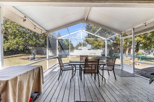 sunroom / solarium with lofted ceiling and a wealth of natural light