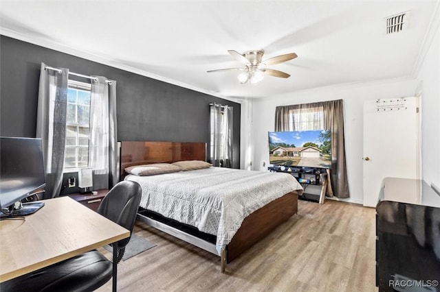 bedroom with ornamental molding, light wood-type flooring, and ceiling fan