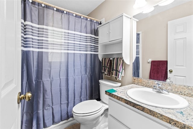 bathroom with vanity, curtained shower, and toilet