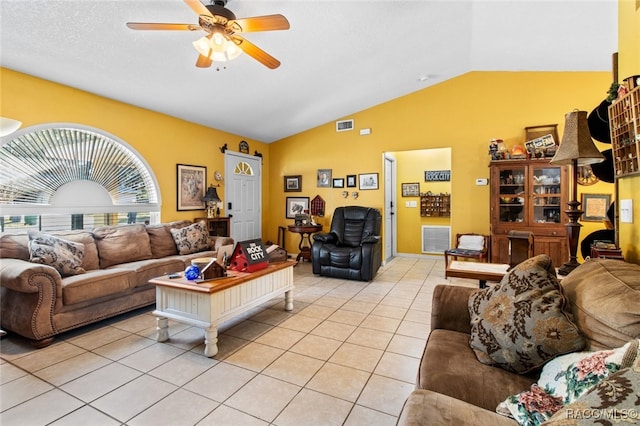 tiled living room with ceiling fan and vaulted ceiling