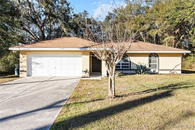 ranch-style home featuring a garage and a front yard