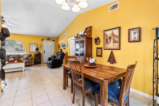 dining room featuring light tile patterned flooring, lofted ceiling, and ceiling fan with notable chandelier