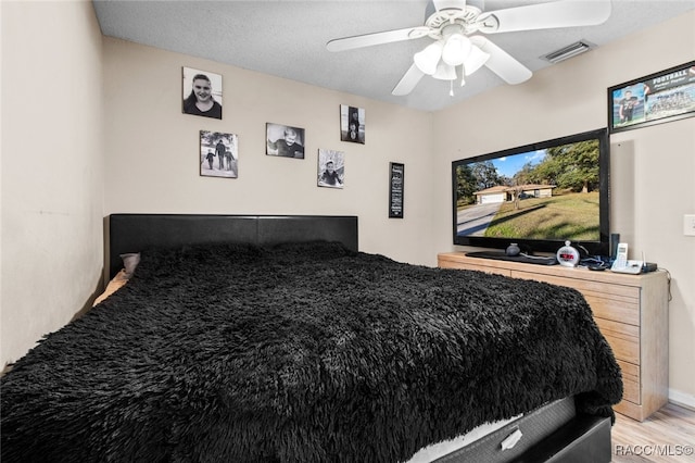 bedroom with ceiling fan and light wood-type flooring