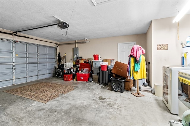 garage with a garage door opener, electric panel, and washer / clothes dryer