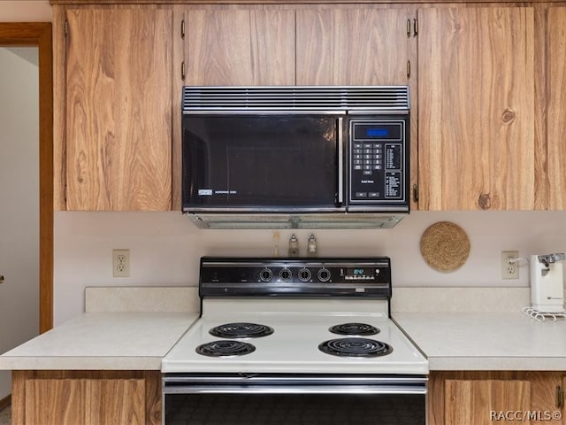 kitchen featuring white range with electric stovetop