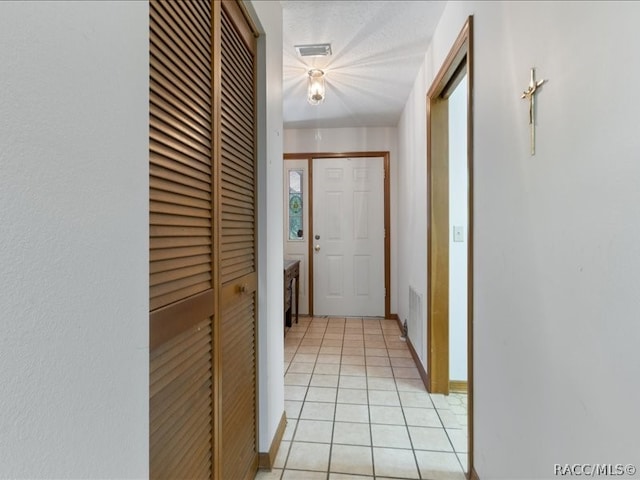 hall with light tile patterned floors