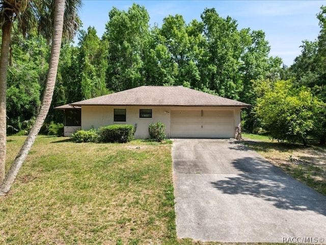 view of front of home with a front yard and a garage