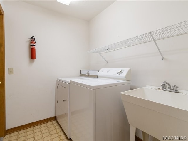 washroom featuring washer and clothes dryer and sink