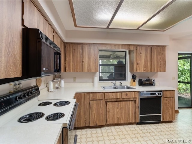 kitchen with sink and white electric range oven