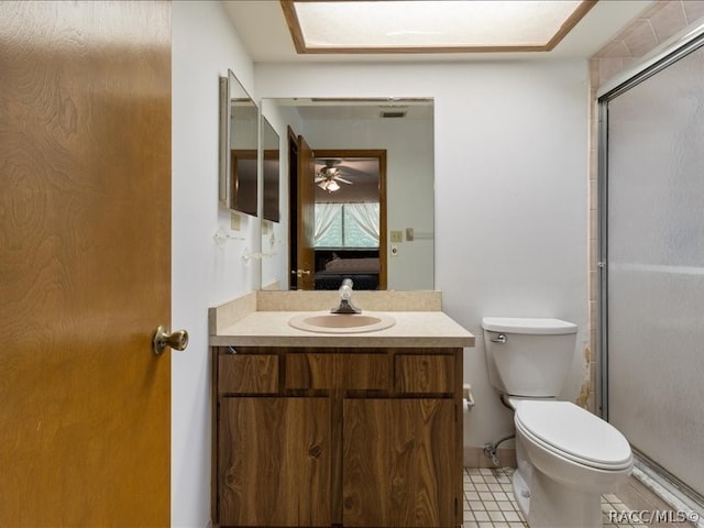 bathroom featuring ceiling fan, tile patterned flooring, an enclosed shower, toilet, and vanity