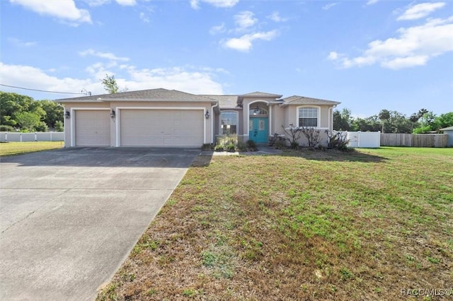 view of front of property with driveway, fence, a front lawn, an attached garage, and stucco siding