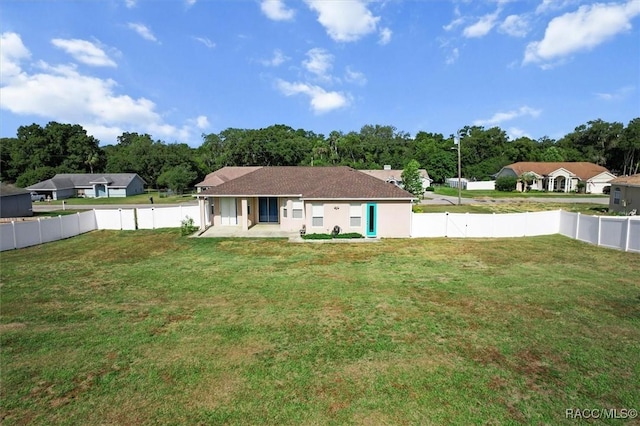 back of property featuring a lawn and a fenced backyard