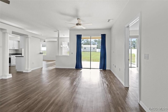 unfurnished living room featuring ceiling fan, baseboards, and dark wood-type flooring