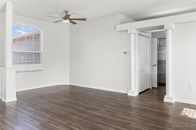 unfurnished bedroom with dark wood-style flooring, baseboards, and ceiling fan