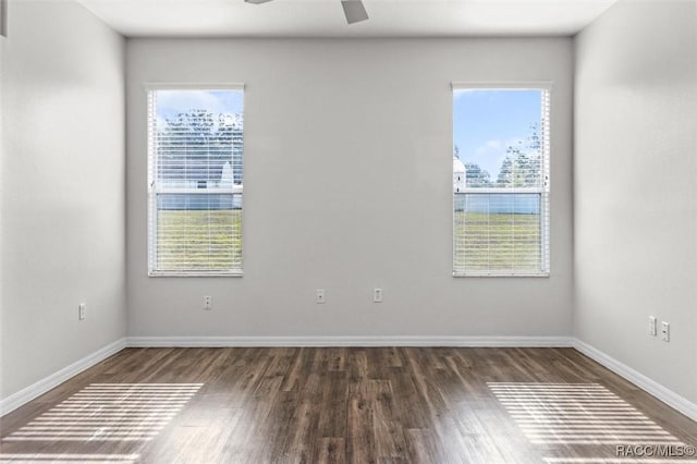 unfurnished room featuring baseboards, a ceiling fan, and wood finished floors