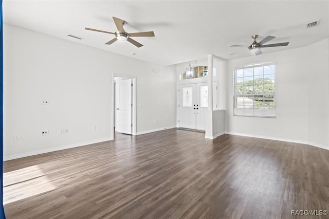 unfurnished living room featuring ceiling fan, visible vents, baseboards, and dark wood-type flooring
