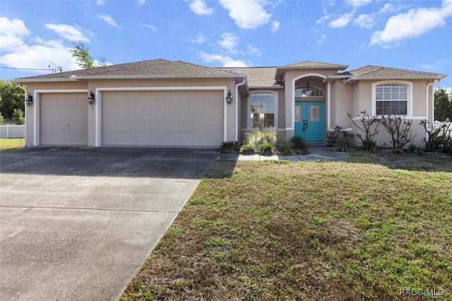 ranch-style home with concrete driveway, a garage, a front yard, and stucco siding