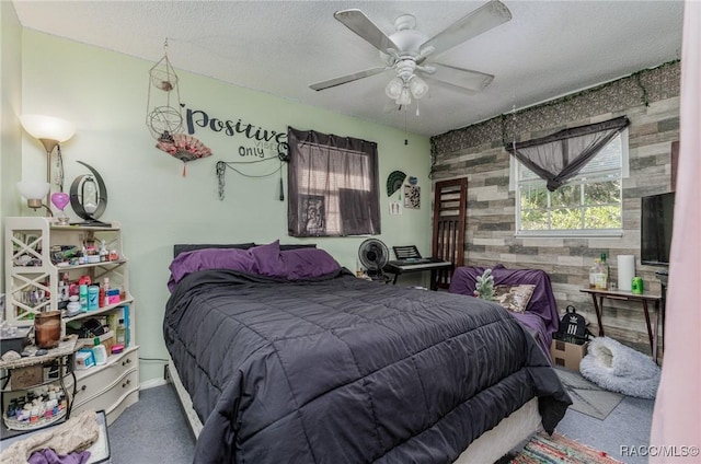 carpeted bedroom with ceiling fan and wooden walls