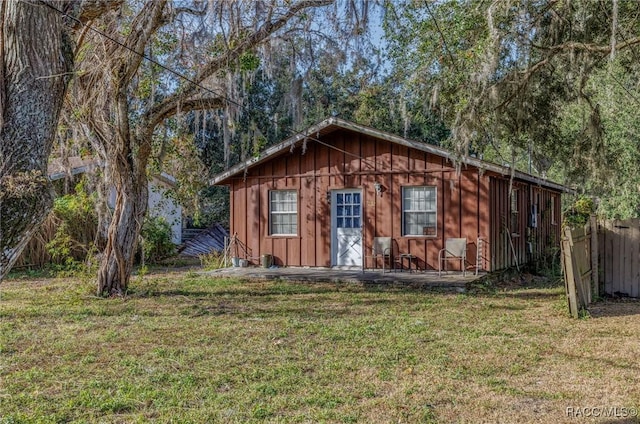 view of outbuilding with a yard