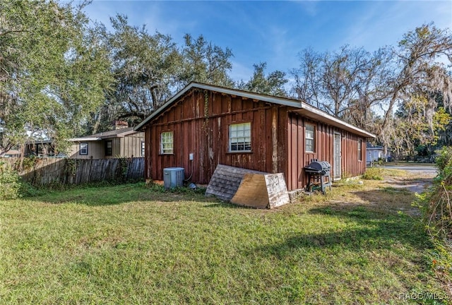 view of side of property with a yard