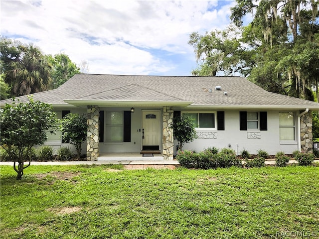 ranch-style home with covered porch and a front lawn