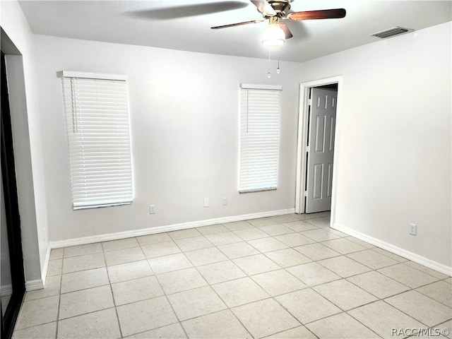 spare room featuring light tile patterned floors and ceiling fan