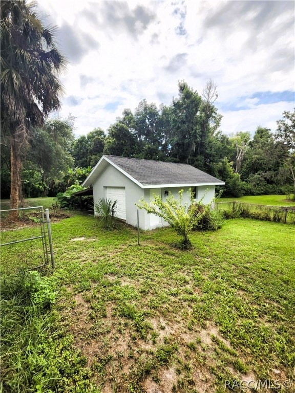 view of yard featuring an outbuilding and a garage