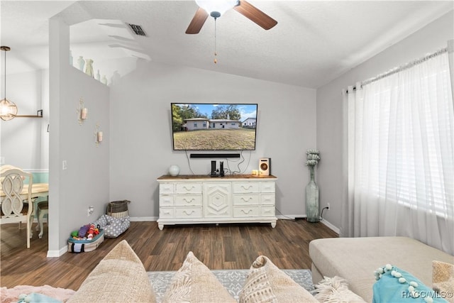 living room with lofted ceiling, a textured ceiling, ceiling fan, and dark hardwood / wood-style flooring