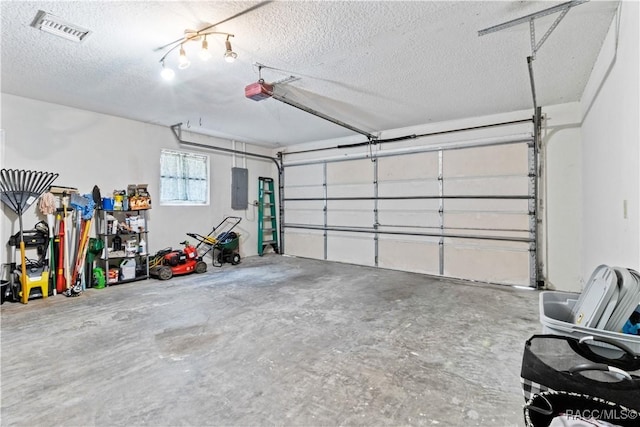 garage with electric panel and a garage door opener